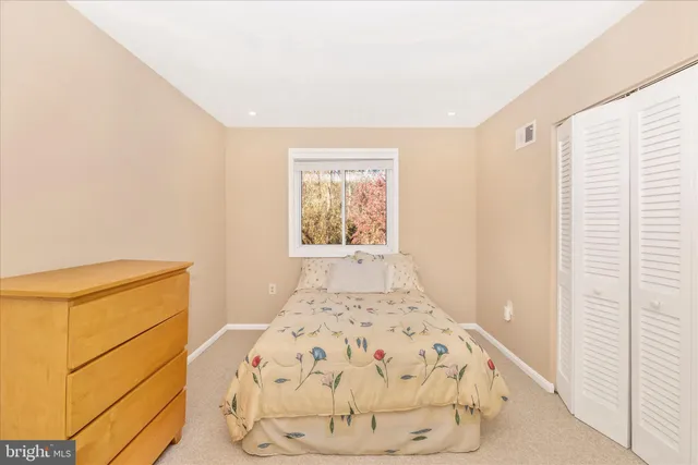 a bedroom with a bed and a mirror