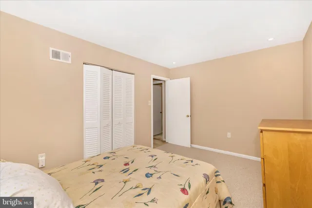 a bedroom with a bed and a chair