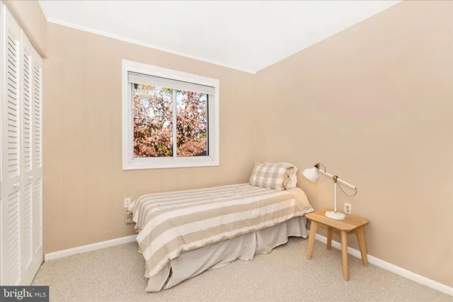 a view of a bedroom with cabinet and floor to ceiling window