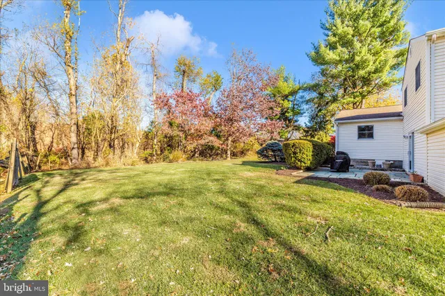 a front view of house with yard and car parked