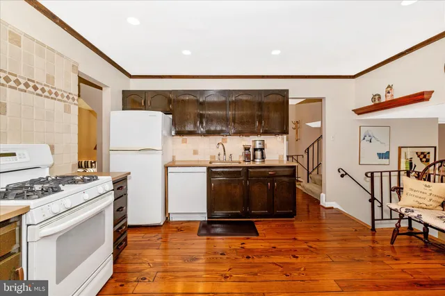 a kitchen with granite countertop a stove and a refrigerator