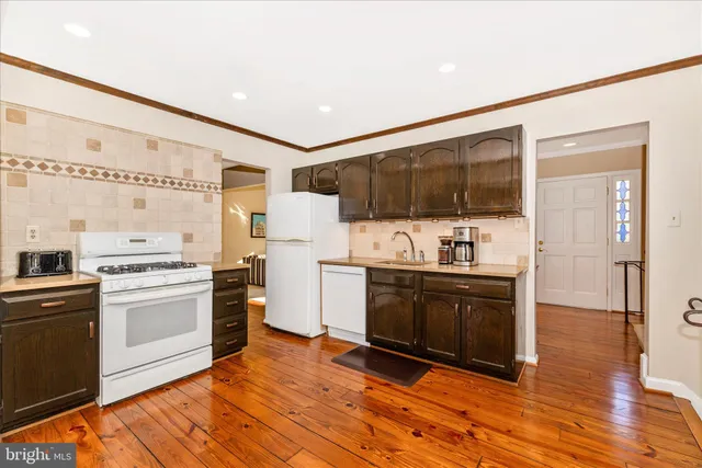 a kitchen with stainless steel appliances a stove a sink and a microwave