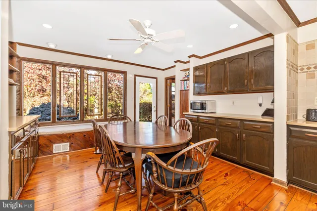a very nice looking dining room with a large window and dining table