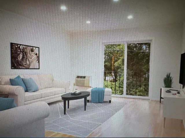 a living room with furniture and a large window