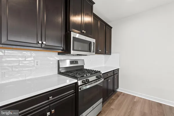 a kitchen with granite countertop stainless steel appliances and wooden cabinets