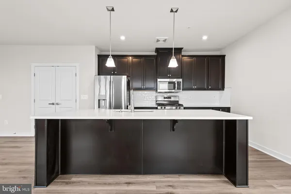a kitchen with stainless steel appliances a sink stove and refrigerator