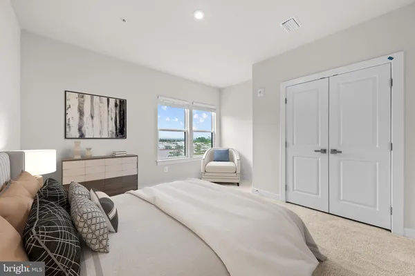 a bedroom with a large bed and a window