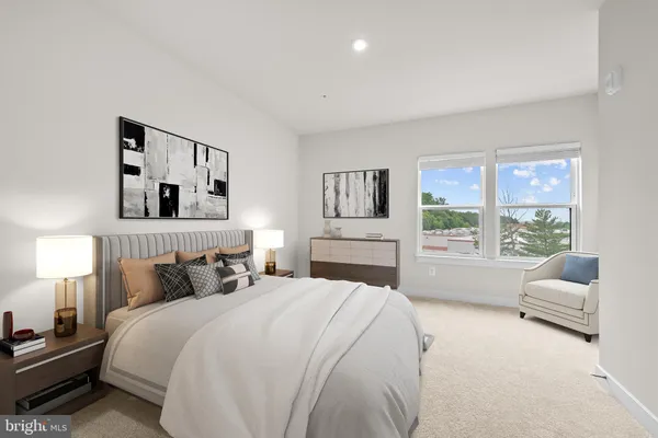 a bedroom with a bed and a large window