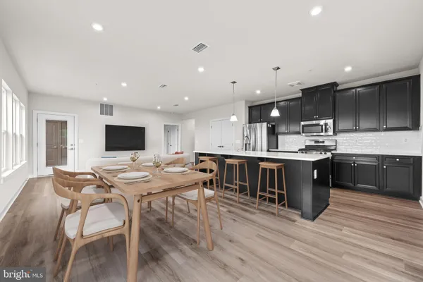 a large kitchen with a table and chairs