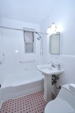 a bathroom with a sink a toilet and mirror
