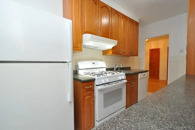 a kitchen with a stove and a refrigerator