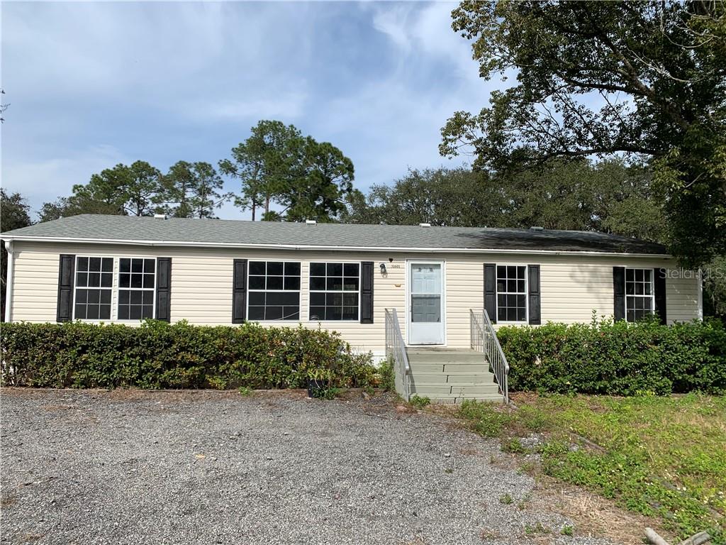 31601 Spruce Drive Eustis, FL 32736 - Photo 1 of 1 front view of house with a yard