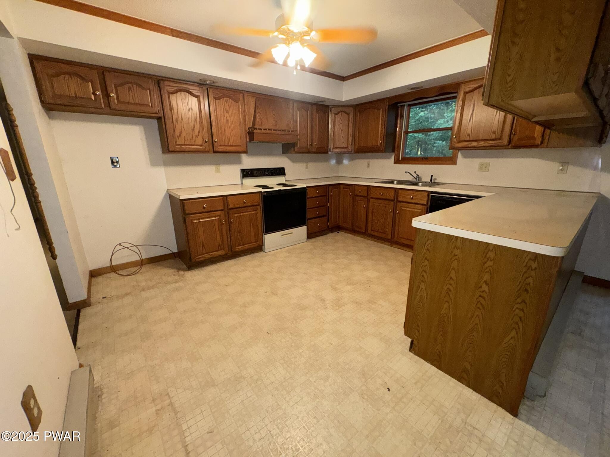 21 Tuthill Road Waymart, PA 18472 - Photo 6 of 49 a kitchen with stainless steel appliances granite countertop a sink a stove and a refrigerator with wooden cabinets