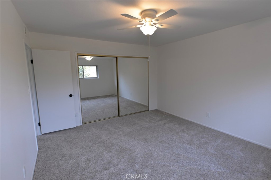 103 El Oriente, Unit 4 San Clemente, CA 92672 - Photo 9 of 19 an empty room with fan and entrance