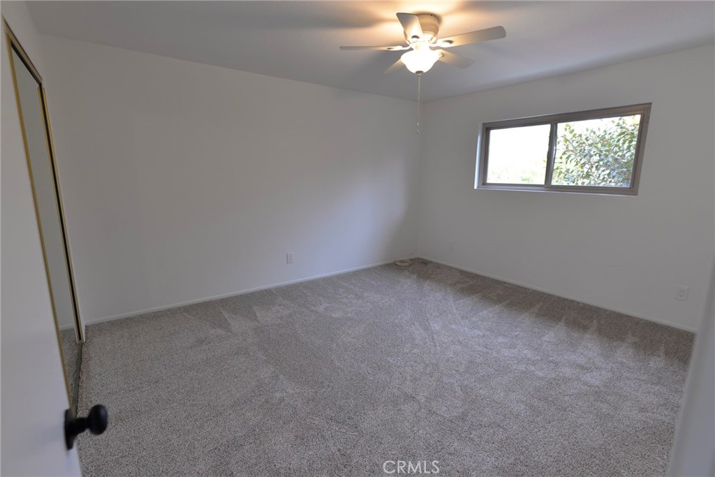 103 El Oriente, Unit 4 San Clemente, CA 92672 - Photo 10 of 19 an empty room with windows and fan