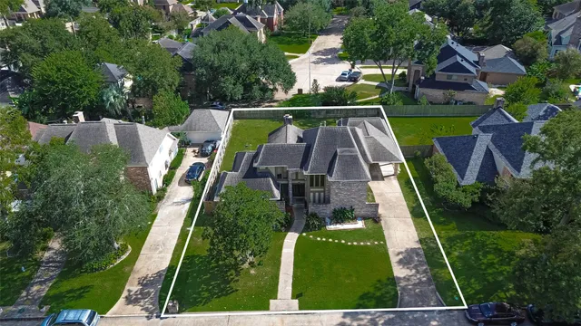 an aerial view of a house with garden space and street view