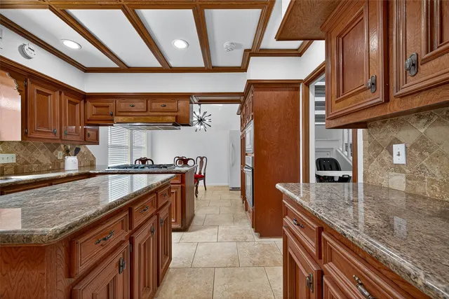 a living room with furniture pool table and a ceiling fan