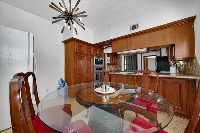 a bathroom with a granite countertop double vanity sink a mirror and shower