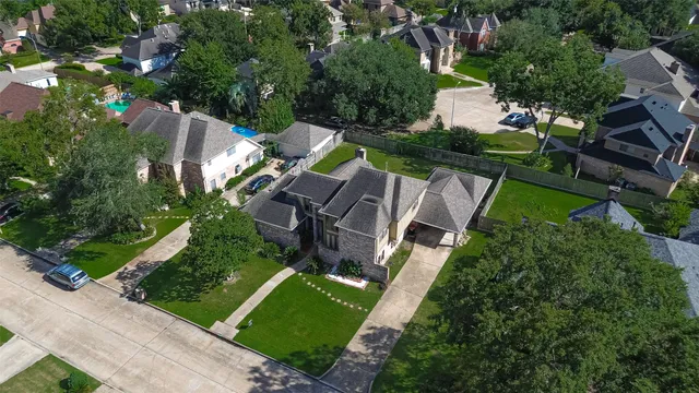 an aerial view of multiple houses with yard