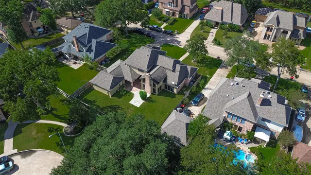 an aerial view of a house with garden space and street view