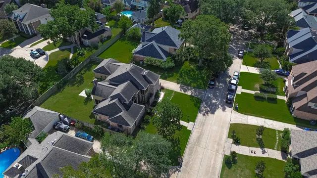 an aerial view of a house with garden space and street view