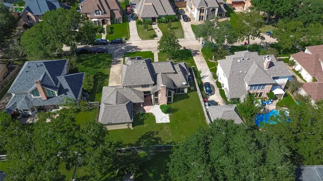 an aerial view of a house with garden space and outdoor seating