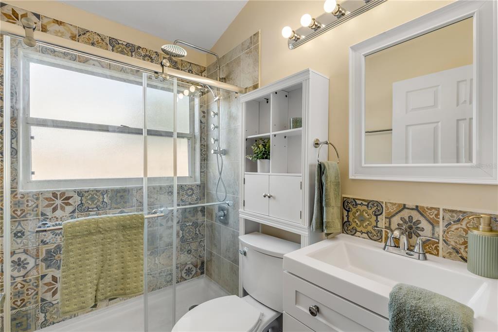 12232 Bronson Way Orlando, FL 32824 - Photo 18 of 32 a bathroom with a sink toilet and shower