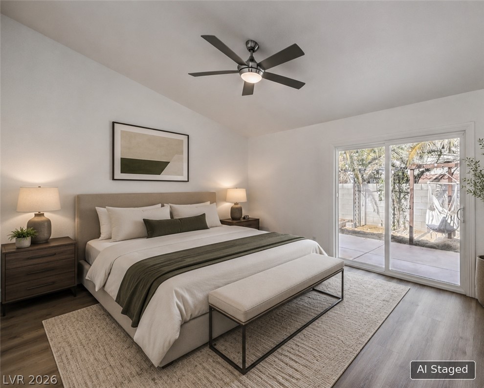 1900 Cardinal Point Street Henderson, NV 89012 - Photo 14 of 32 A well-lit bedroom features vaulted ceilings and direct access to an outdoor area through sliding glass doors.