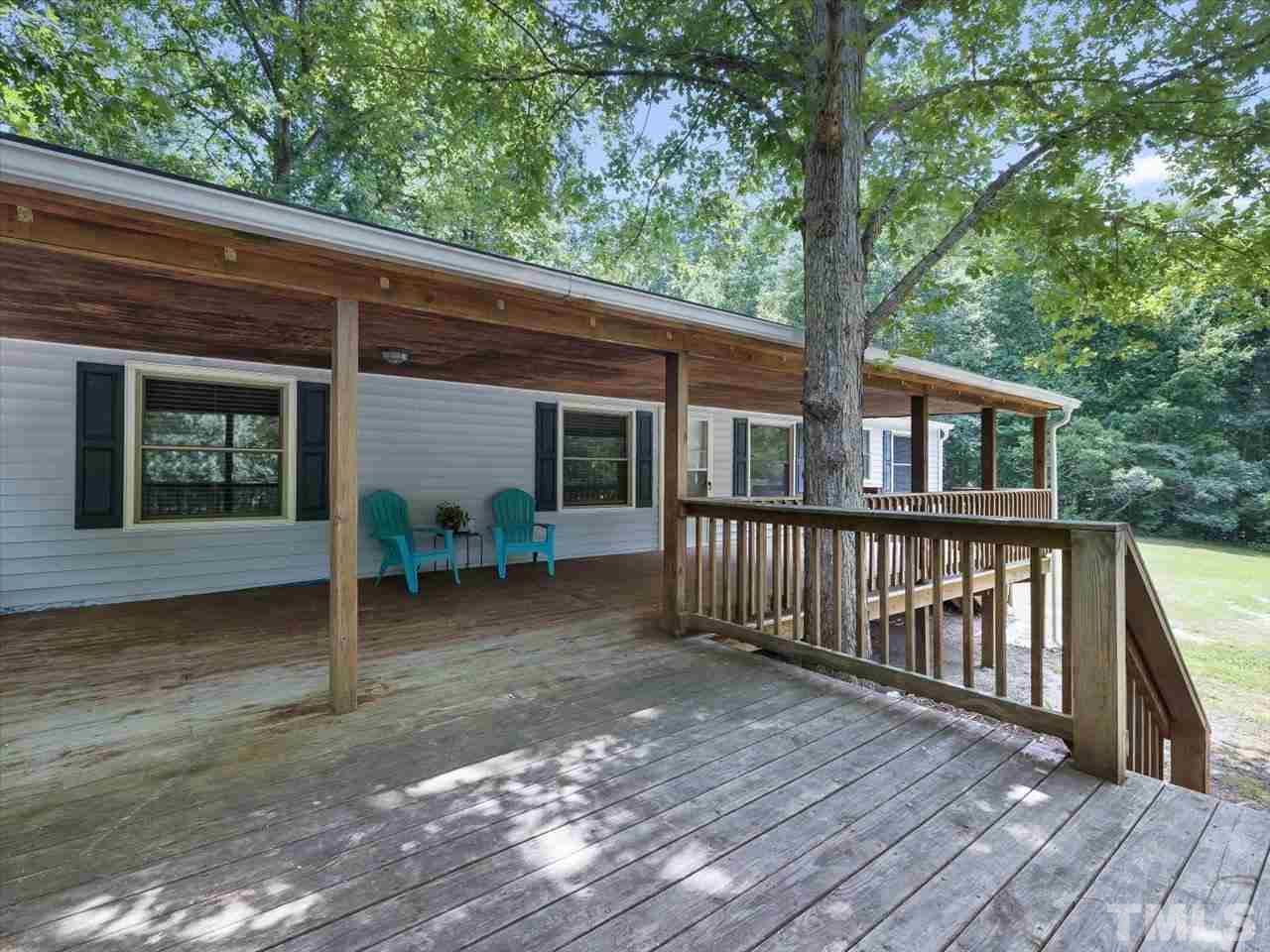719 Russell Loop Road Prospect Hill, NC 27314 - Photo 3 of 30 Huge & Well built deck 14x12 and covered porch 37x13 with 2 sets of stairs!