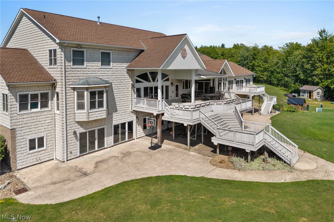 9419 Robinson Road Chardon, OH 44024 - Photo 10 of 49 Expansive rear exterior featuring multiple outdoor decks, a lower-level patio, and a shingle-style facade