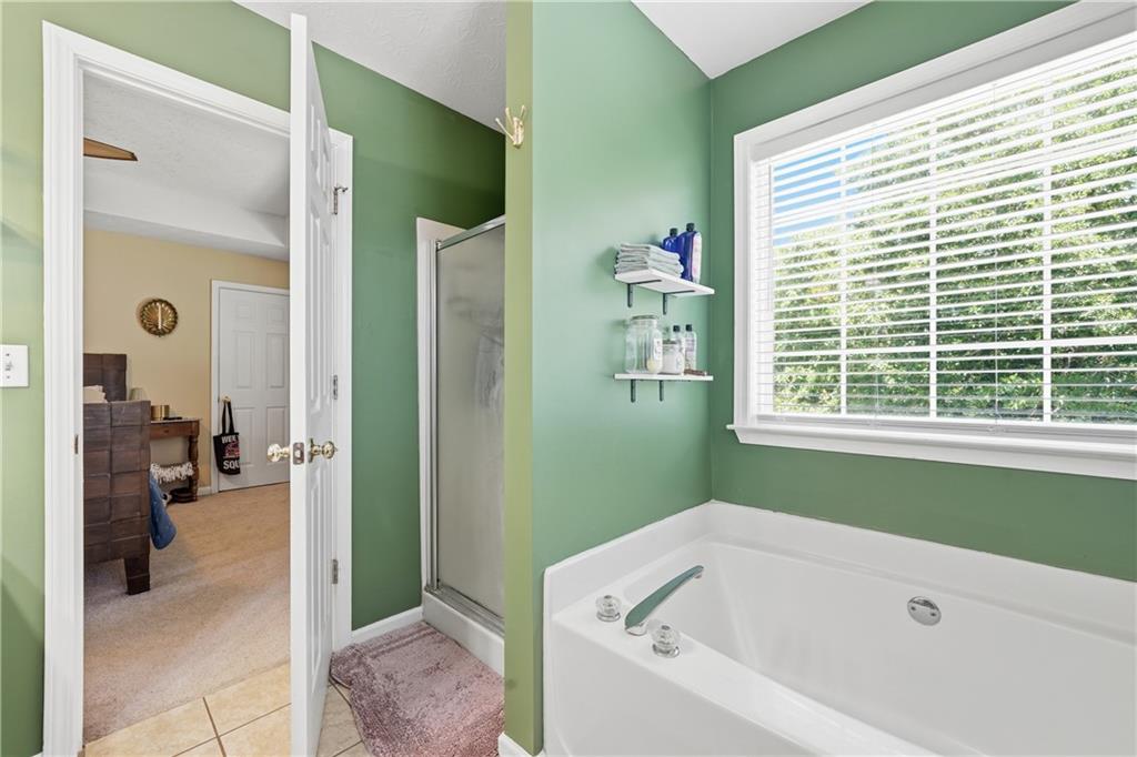 137 Orchard Way Southeast Calhoun, GA 30701 - Photo 19 of 39 a bathroom with a bathtub and a shower