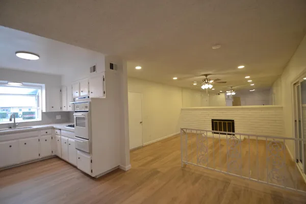a view of a kitchen with a sink and microwave