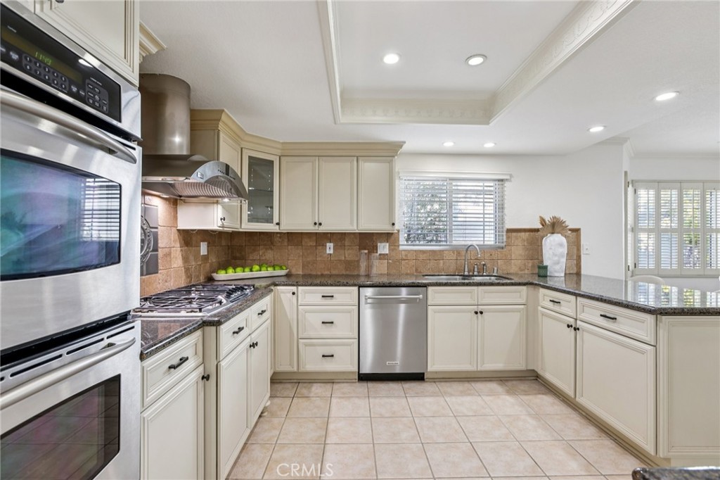 2001 Bataan Road Redondo Beach, CA 90278 - Photo 11 of 56 a kitchen with stainless steel appliances granite countertop a stove a sink and a microwave