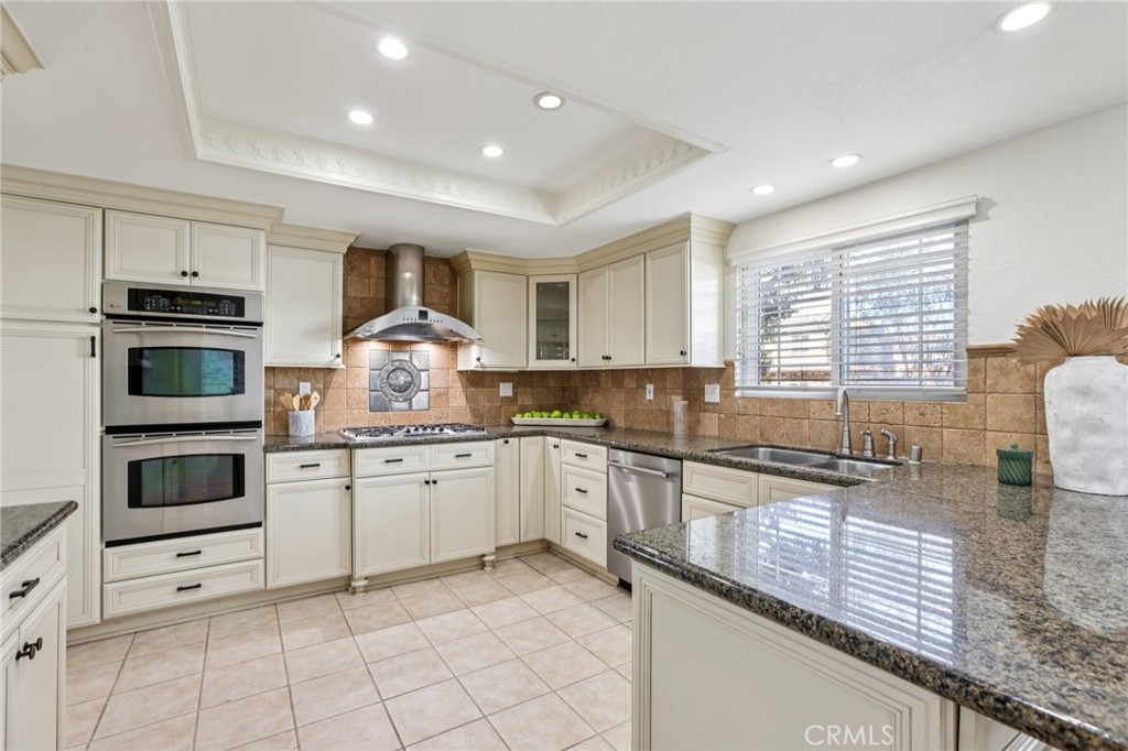 2001 Bataan Road Redondo Beach, CA 90278 - Photo 12 of 56 a kitchen with granite countertop white cabinets appliances and a counter top space
