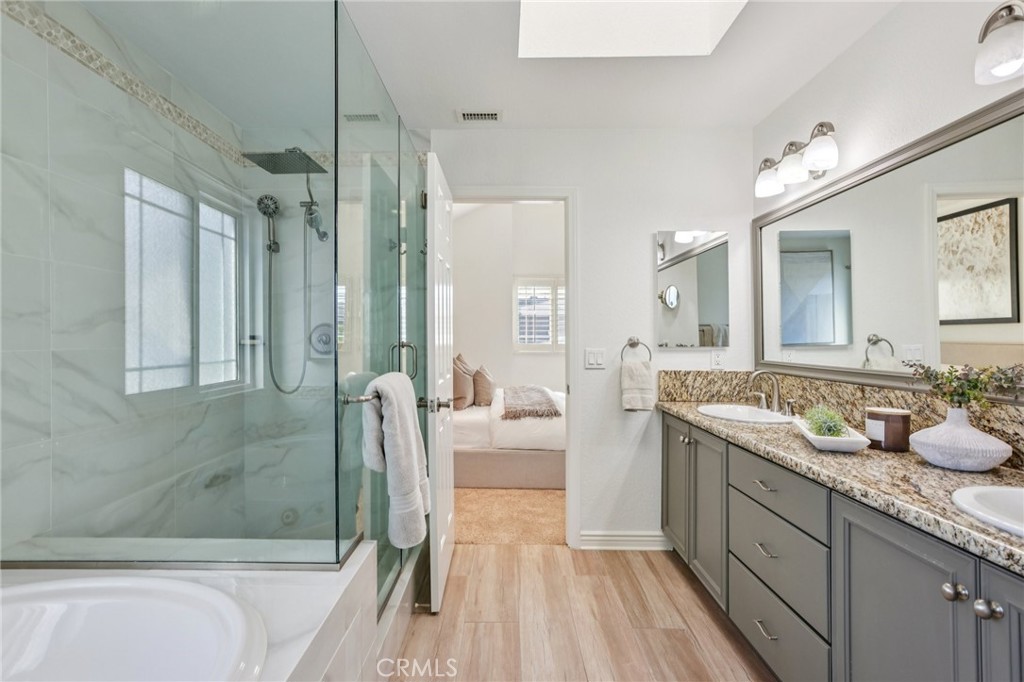 2001 Bataan Road Redondo Beach, CA 90278 - Photo 37 of 56 a spacious bathroom with a granite countertop tub sink a mirror a shower and vanity