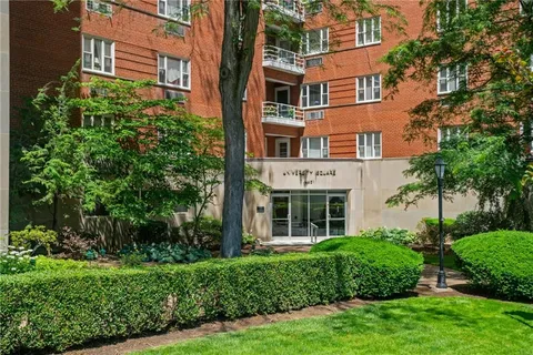 a view of a brick building next to a yard