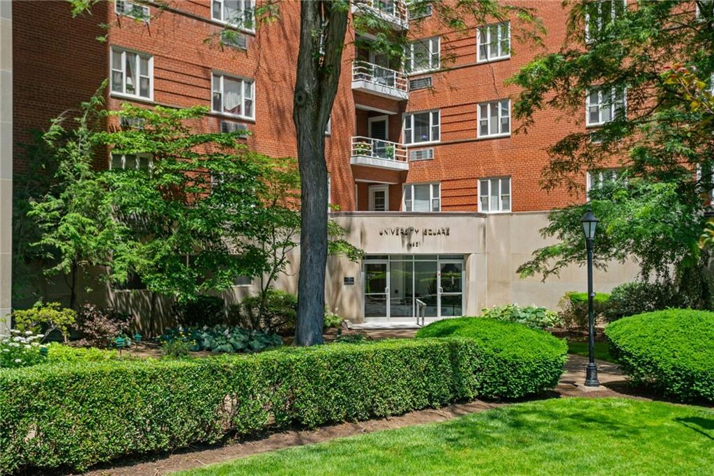 a view of a brick building next to a yard