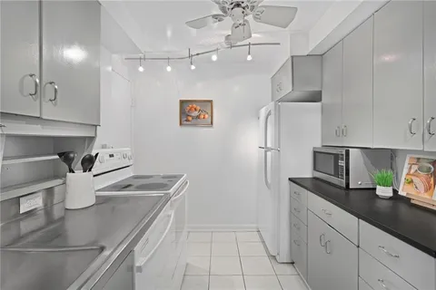 a kitchen with stainless steel appliances granite countertop a sink a stove and refrigerator