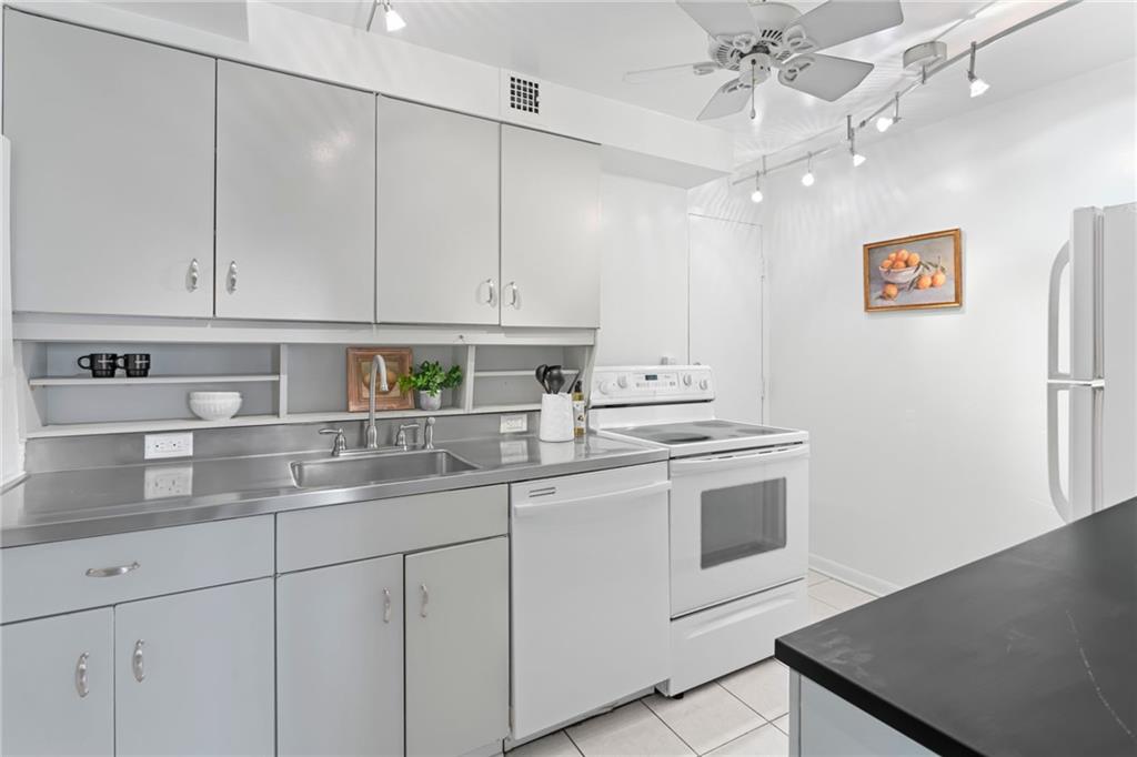 4601 Fifth Avenue, Unit 226 Pittsburgh, PA 15213 - Photo 12 of 34 a kitchen with stainless steel appliances granite countertop a sink a stove and a refrigerator