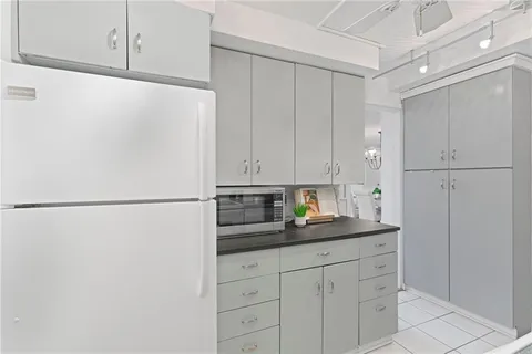 a kitchen with refrigerator and cabinets