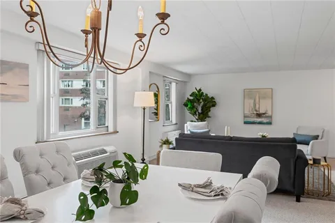 a living room with furniture and white walls