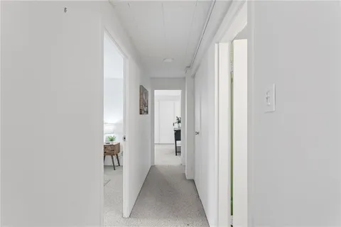 a view of a hallway with a white walls