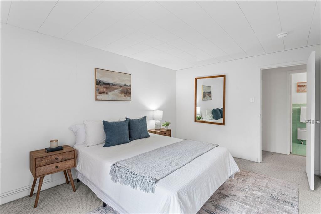 4601 Fifth Avenue, Unit 226 Pittsburgh, PA 15213 - Photo 18 of 34 a bedroom with a bed and a chair