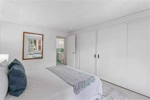 a bedroom with a bed and a couch