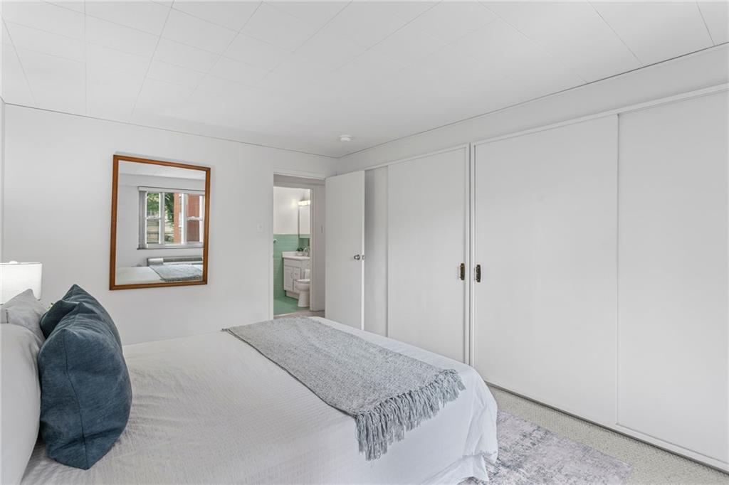 4601 Fifth Avenue, Unit 226 Pittsburgh, PA 15213 - Photo 19 of 34 a bedroom with a bed and a couch