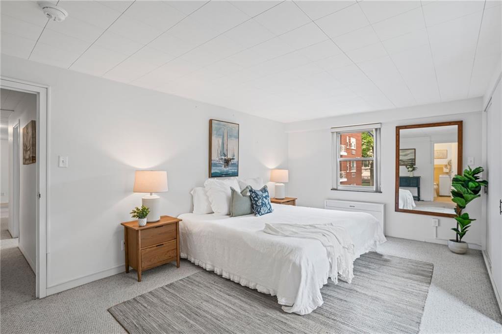 4601 Fifth Avenue, Unit 226 Pittsburgh, PA 15213 - Photo 22 of 34 a bedroom with a bed and a couch