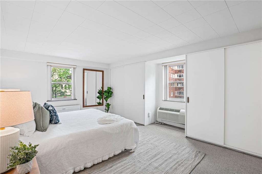 4601 Fifth Avenue, Unit 226 Pittsburgh, PA 15213 - Photo 23 of 34 a bedroom with a bed and wooden floor