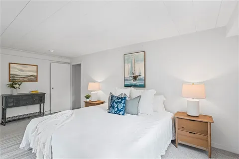 a bedroom with bed and window