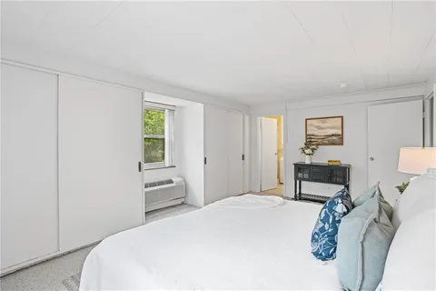 a bedroom with a bed a table and chair