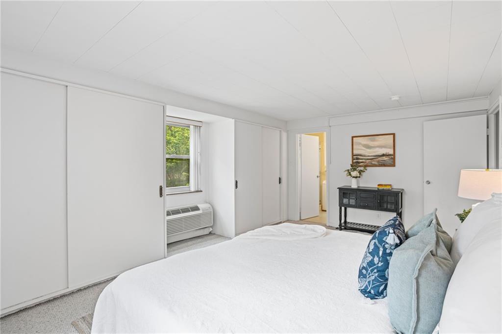 4601 Fifth Avenue, Unit 226 Pittsburgh, PA 15213 - Photo 25 of 34 a bedroom with a bed a table and chair